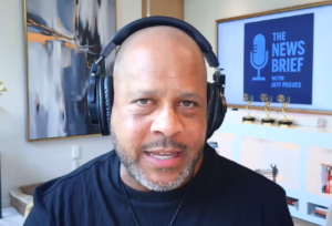 Photo of Jeff Pegues speaking into the camera wearing headphones